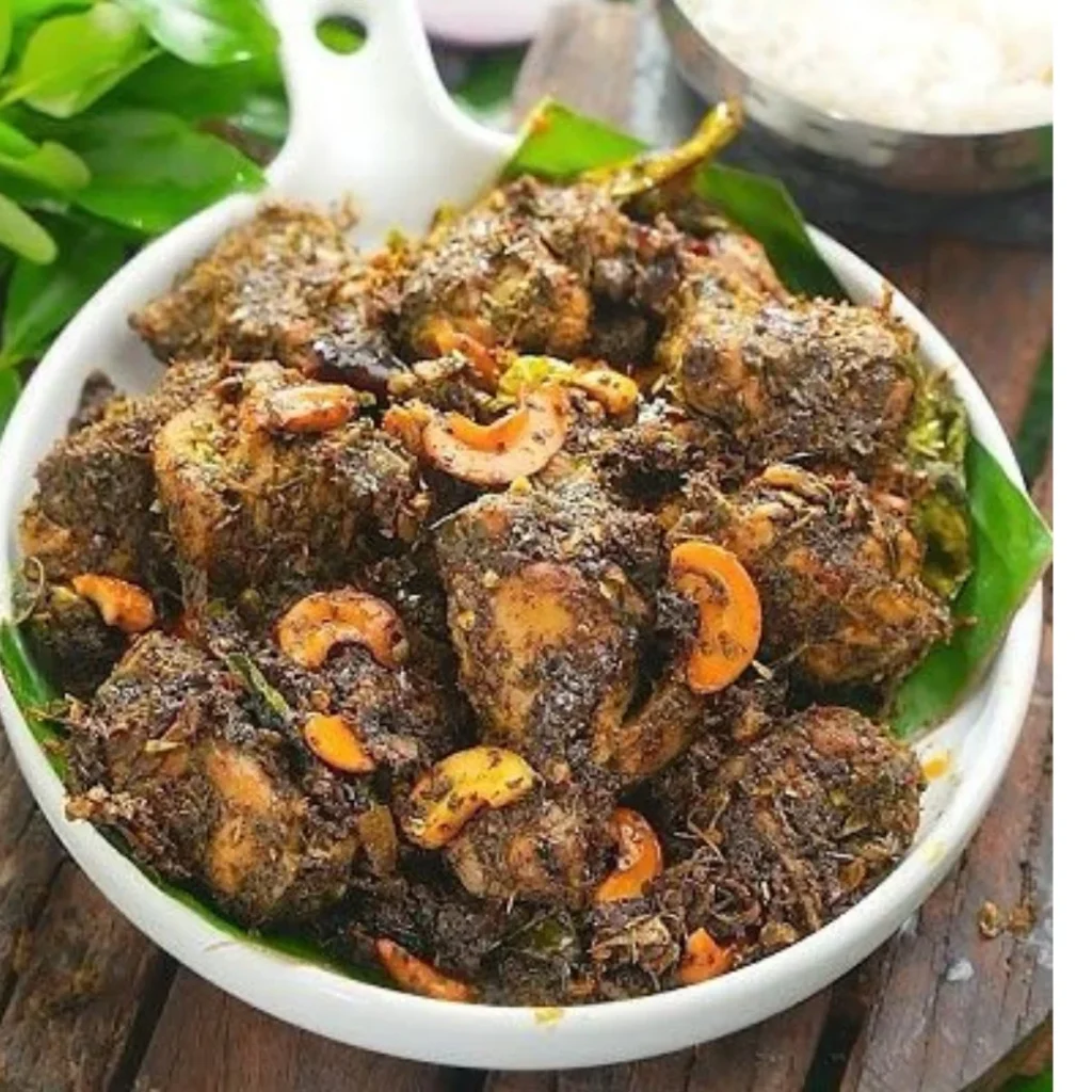 "Spicy Kerala-style beef fry with cashews and curry leaves in a white bowl"