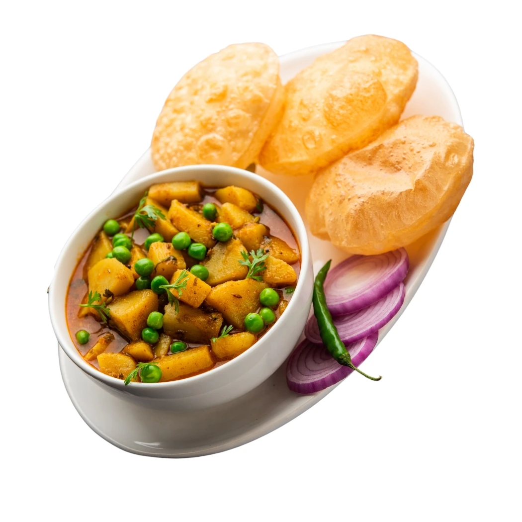 "Aloo matar curry served with puris, sliced red onions and green chili - traditional Indian potato and green peas curry"