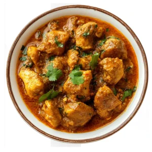 "Authentic Indian chicken curry with rich orange-colored gravy garnished with fresh cilantro in a white bowl with brown rim"
